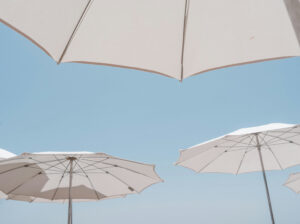 White umbrellas in a blue sky